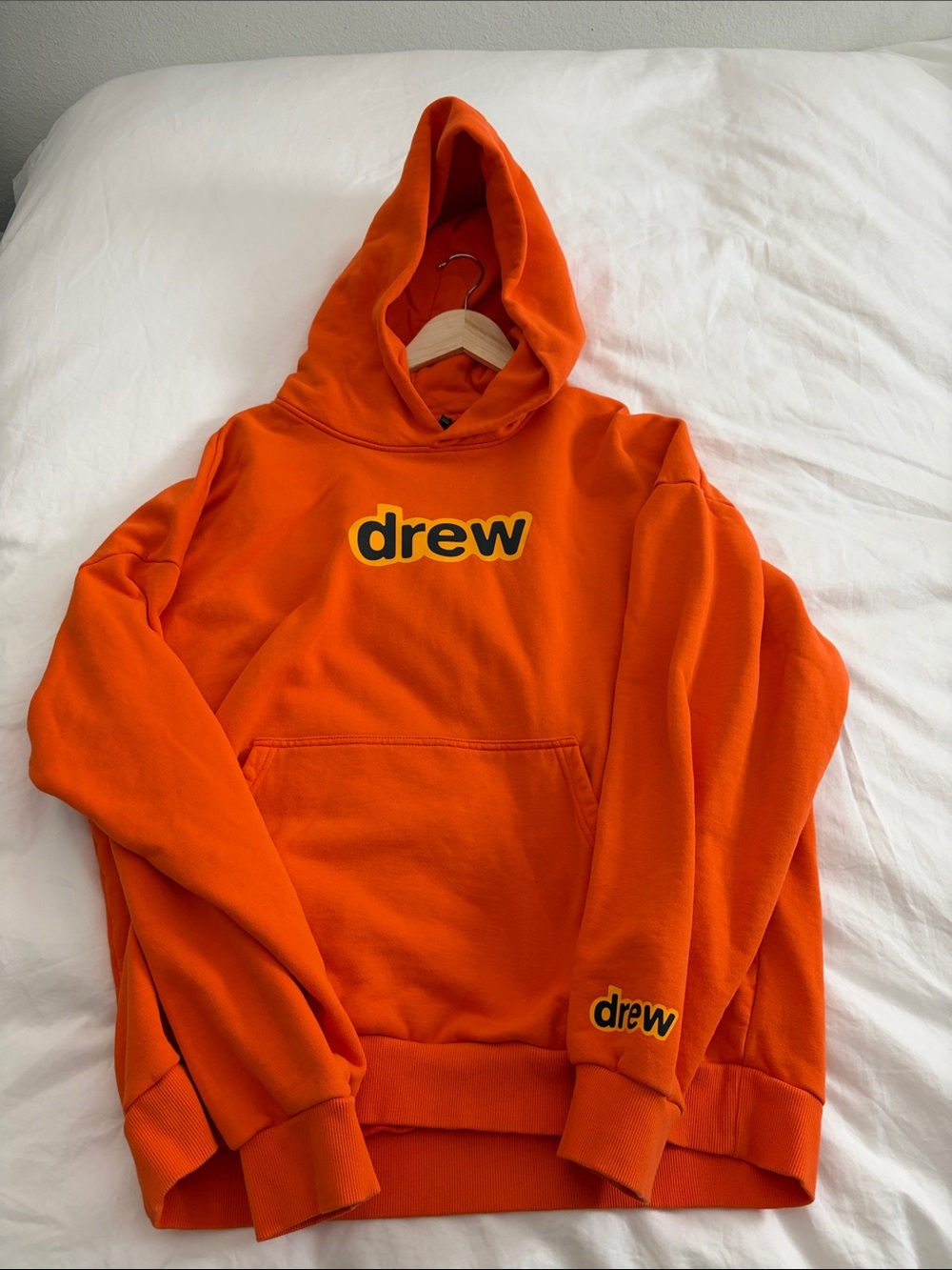 drew house orange logo hoodie with black-yellow trim